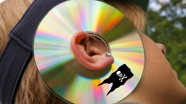 Woman wearing a pirated CD around ear, symbolizing listening to arguments