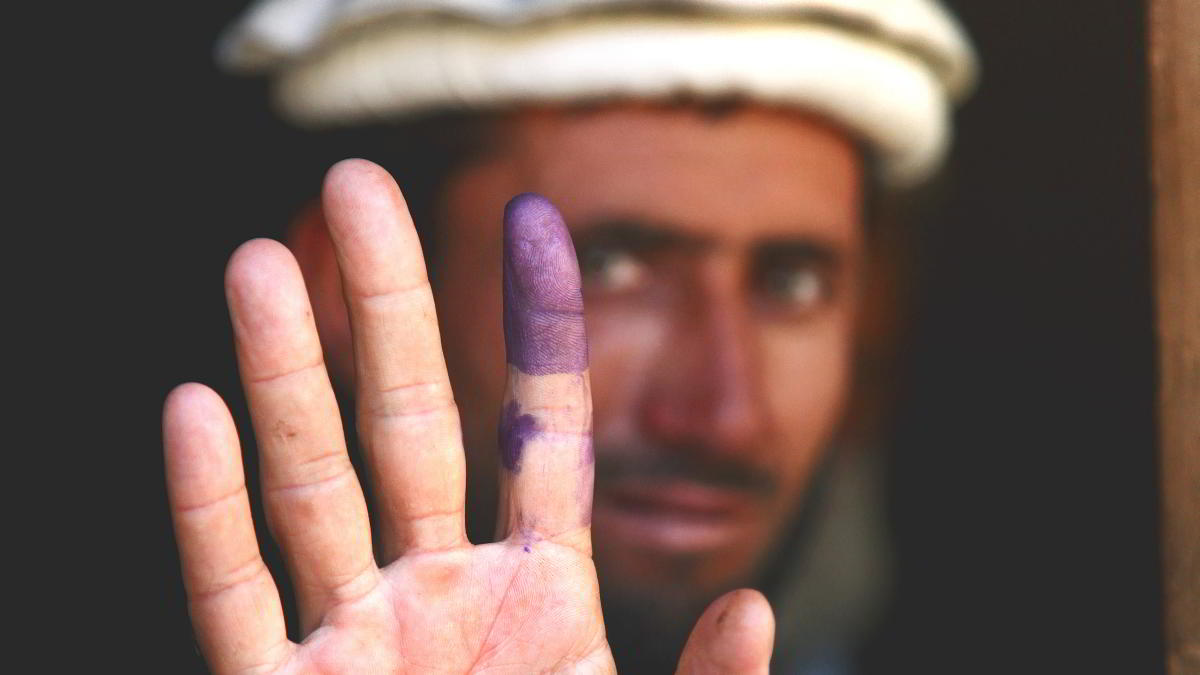 Afghan Voter with purple finger. CC-BY-NC by U.S. Army Garrison - Miami